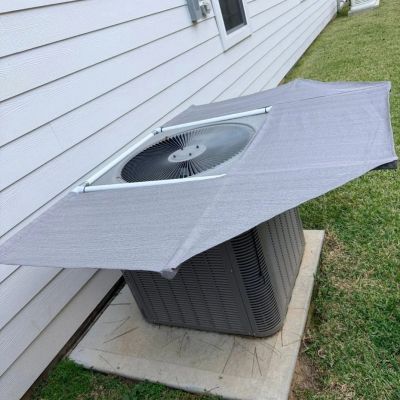 Gray protective cover on an outdoor air conditioning unit.