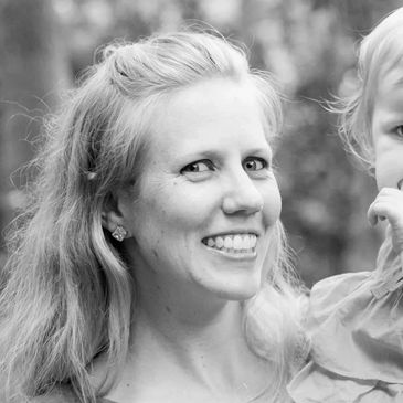 A woman carrying a baby