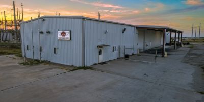 Industrial building at sunset with a sign on the wall.