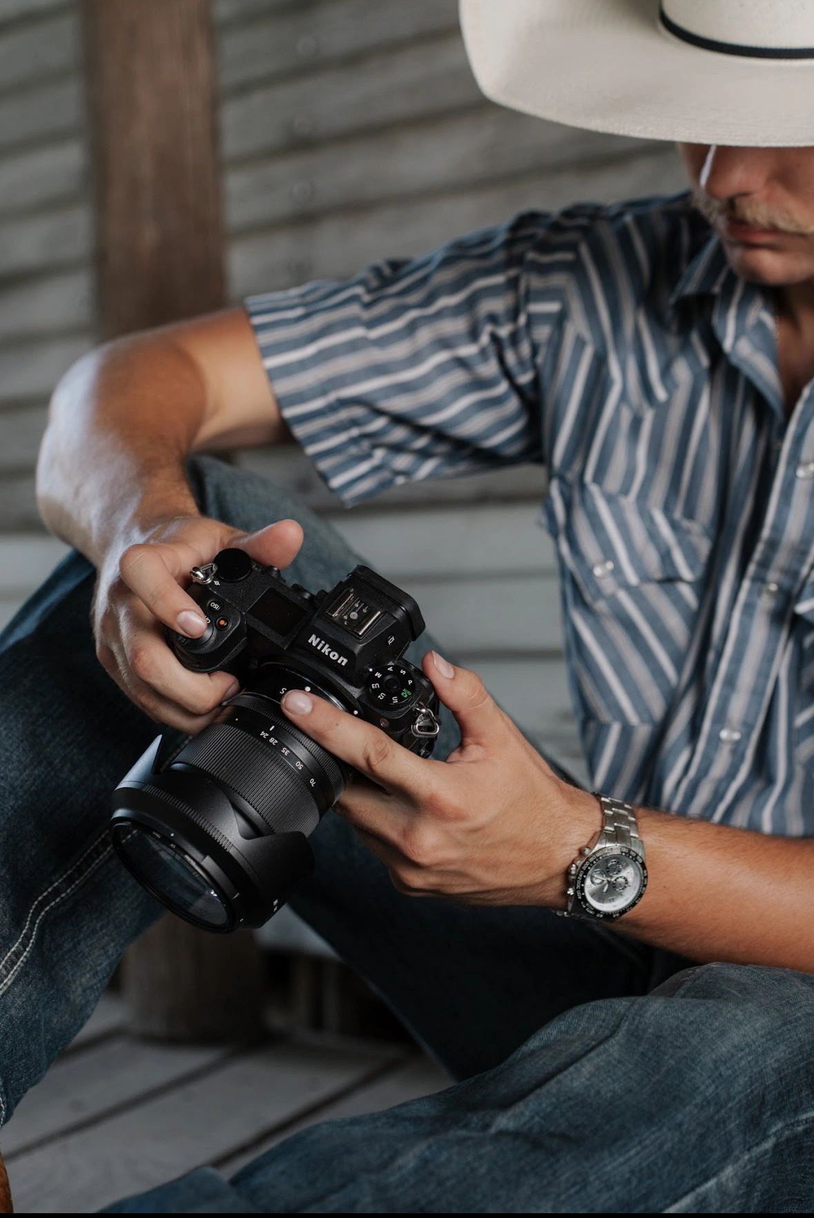 Photographer holding a Nikon camera during a Photo Famous Studios production