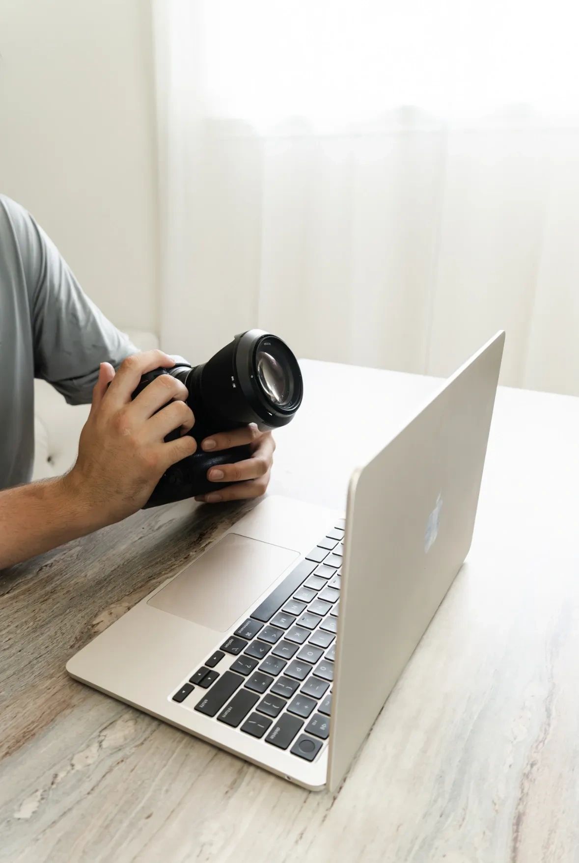 Photography and creative production workspace with camera and laptop