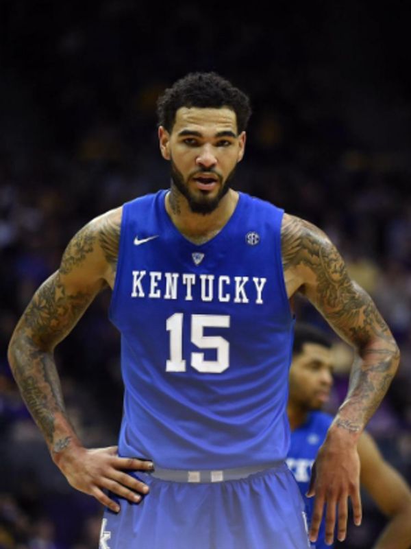 Kentucky basketball player number 15 with tattoos on his arms during a game.