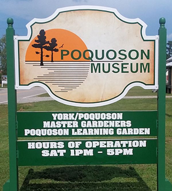 Sign for Poquoson Museum with garden and hours info.