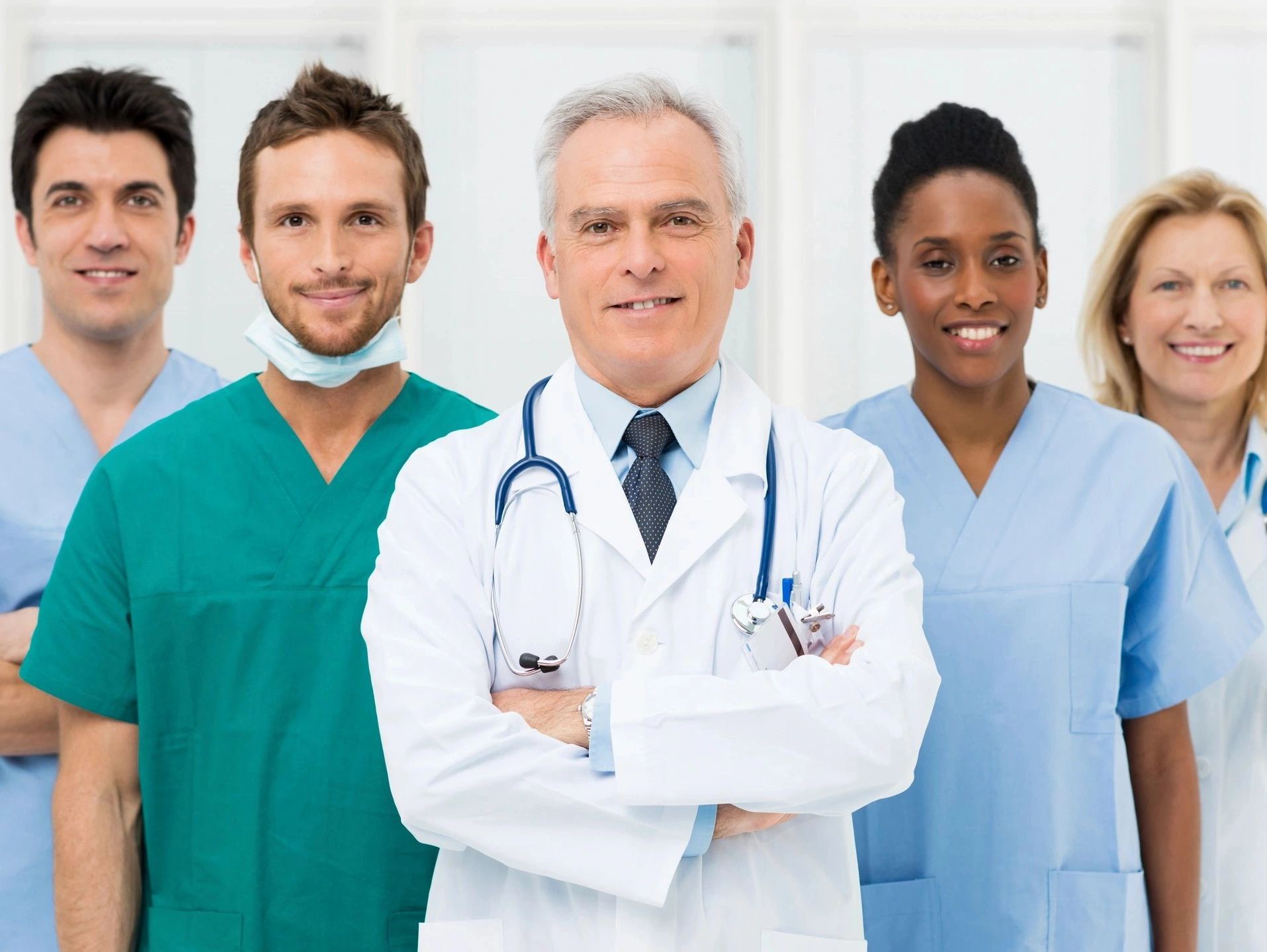 A diverse group of confident healthcare professionals smiling together.