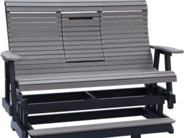 A gray wooden outdoor glider bench with armrests and a slatted design.
