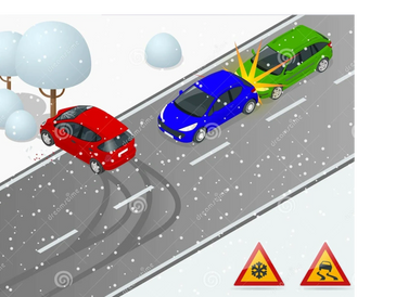 Light snow falling on an Evansville street as cars drive cautiously in the evening.