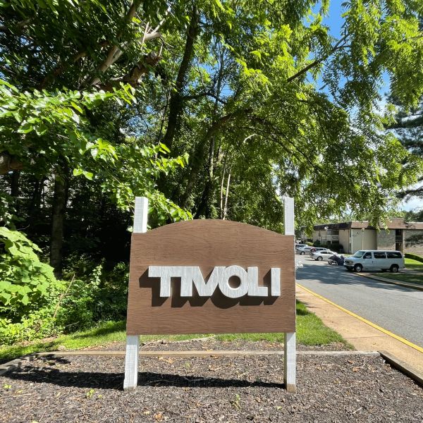 Wooden signboard with 'TIVOLI' in white letters.