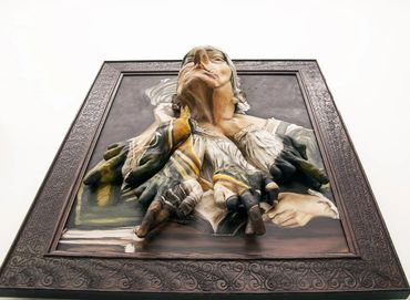 A striking 3D painting of a woman seemingly emerging from the frame.