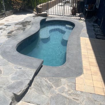 Pool with stone and tile deck