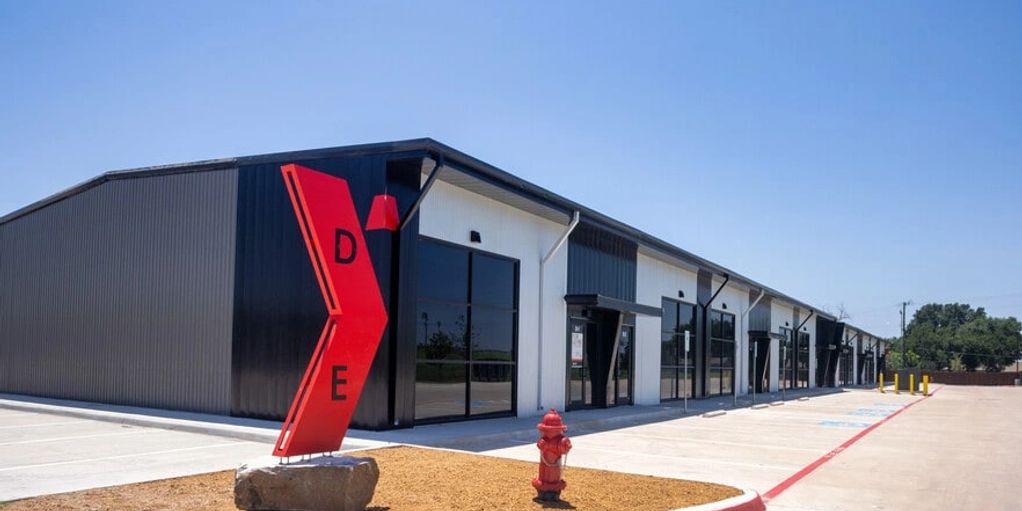 Modern industrial building with red D and E signs.