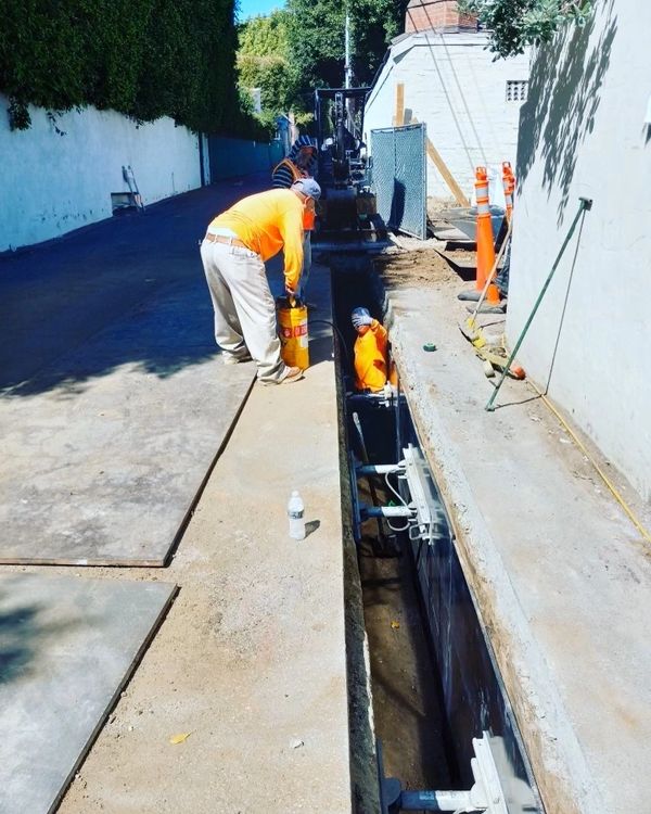 Utility trenching in alleyway.