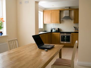 Interior of kitchen with laptop on kitchen table in Jacksonville, Florida