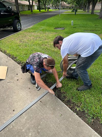 Two men are working together