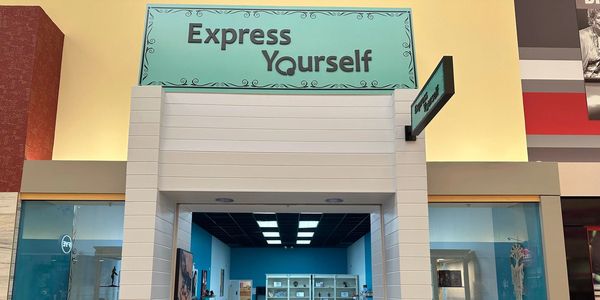 Storefront with a sign 'Express Yourself'.