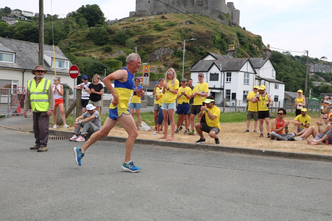 Support crew giving Chris a huge cheer as he passes Harlech Castle