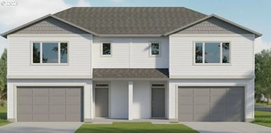 Modern duplex house with two garages and symmetrical design.