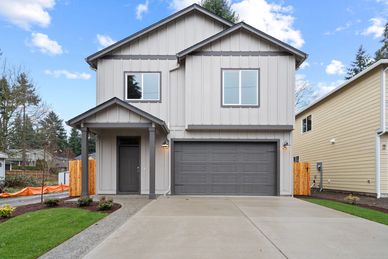 Modern two-story house with gray siding and a double garage.