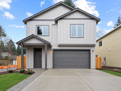 Modern two-story house with gray siding and a double garage.