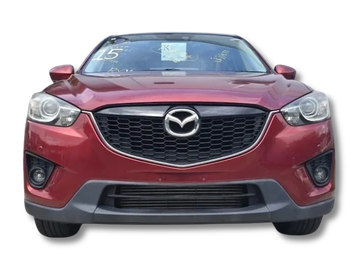 Front view of a red Mazda SUV with a prominent grille and headlights.