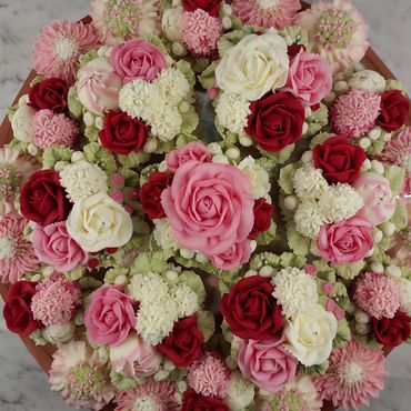 Elegant combination of floral buttercream cupcakes arranged on a platter board