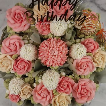 Elegant combination of floral buttercream cupcakes arranged on a platter board