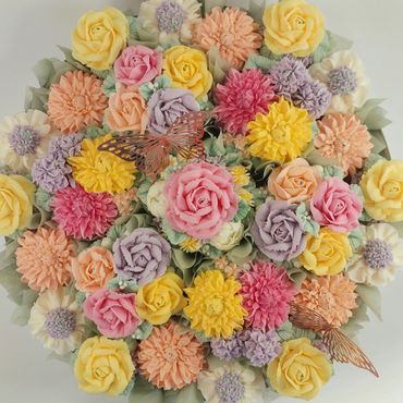 A vibrant bouquet of pastel-colored flowers with delicate butterflies.