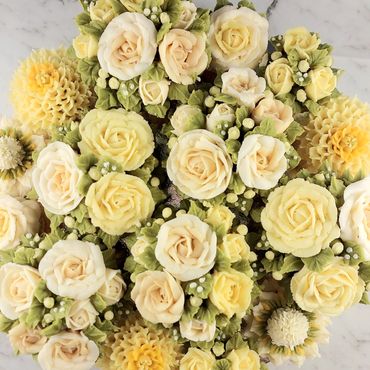 Elegant combination of floral buttercream cupcakes arranged on a platter board