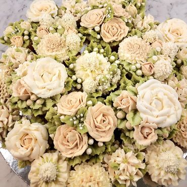 Elegant combination of floral buttercream cupcakes arranged on a platter board