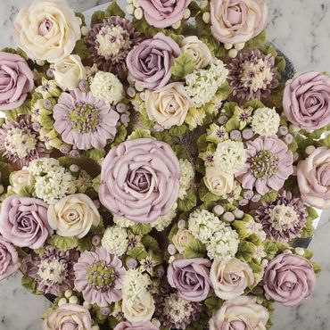 Elegant combination of floral buttercream cupcakes arranged on a platter board