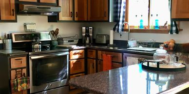 Modern kitchen with stainless steel appliances and wooden cabinets.
