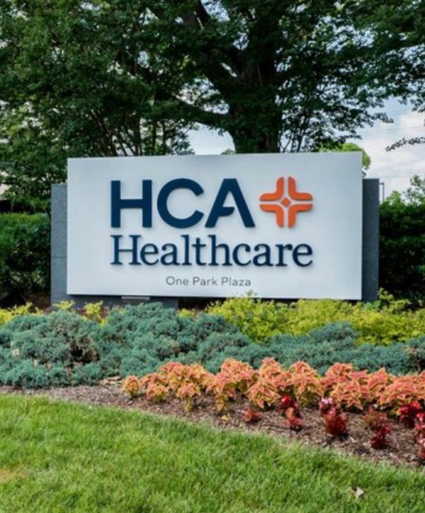 HCA Healthcare sign surrounded by landscaping.