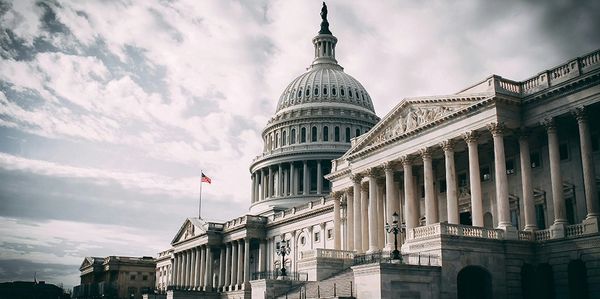 The United States Capitol building under a dramatic cloudy sky.