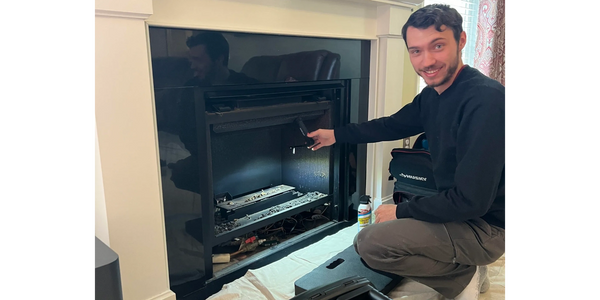 technician servicing a gas fireplace