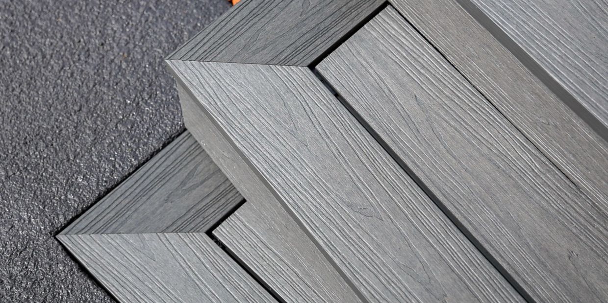 Close-up of gray wood-textured decking with precise corner joints.