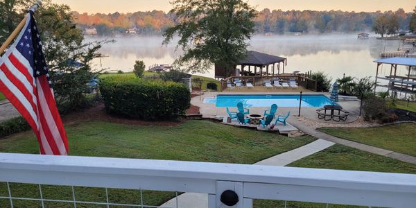 View form deck of pool, dock and lake