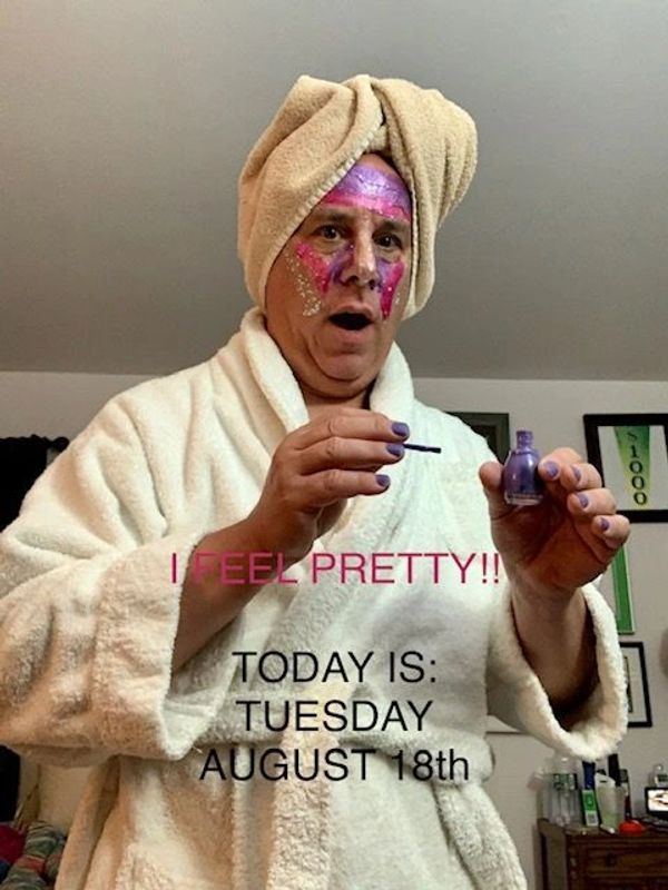 Man in bathrobe with towel turban and face paint holding nail polish, captioned "I FEEL PRETTY!!"