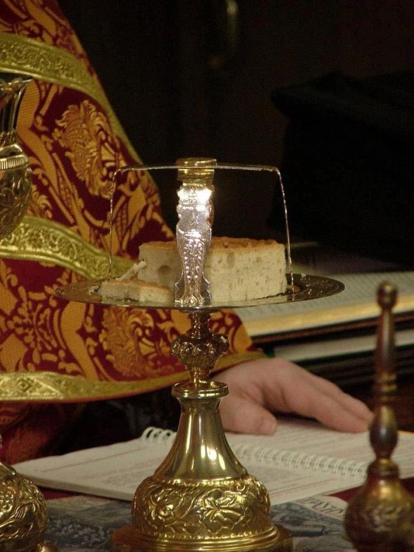 Religious bread on an ornate holder during a ritual.