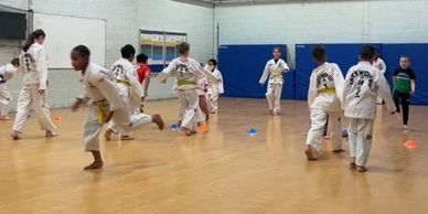students taking part in fun warm up session for taekwondo class 