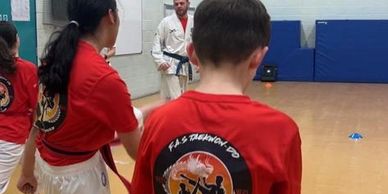 taekwondo students having fun in warm up 