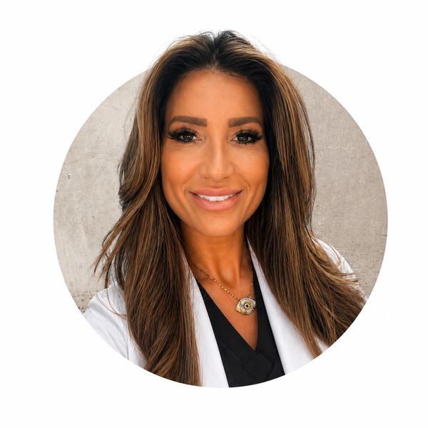 Smiling woman with long hair in professional attire.
