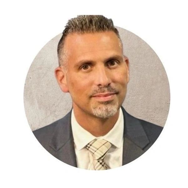 Professional man in suit and tie with short hair.