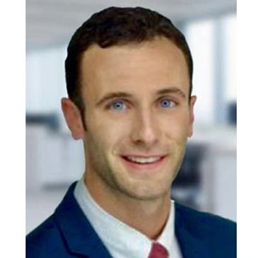 Professional headshot of a smiling man in business attire.