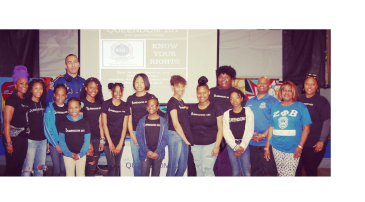 Group photo of diverse individuals at a community event about knowing your rights.