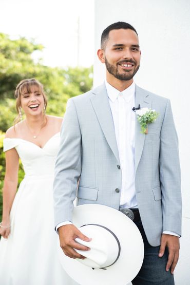 Bride sneaks up behind groom for a surprise first look.