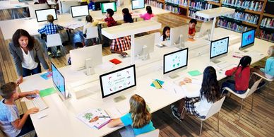 developers seated in an open work space environment and able to interact.