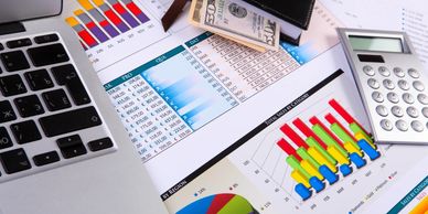 Colorful visual charts and reports about financial statements with a laptop.