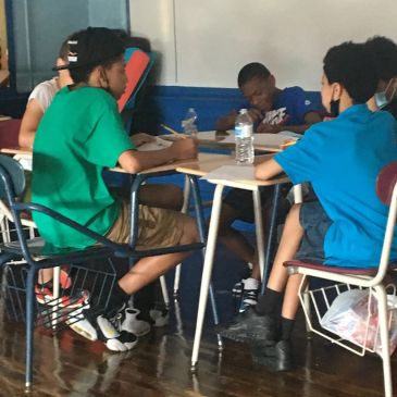 Students sitting around a table engaged in group work or discussion.