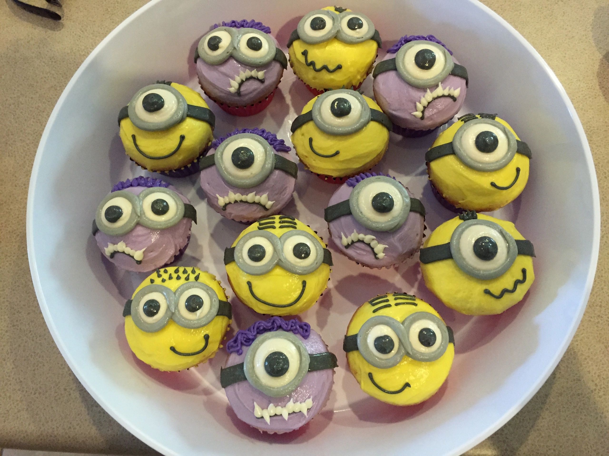 Minion-themed cupcakes with yellow and purple frosting.