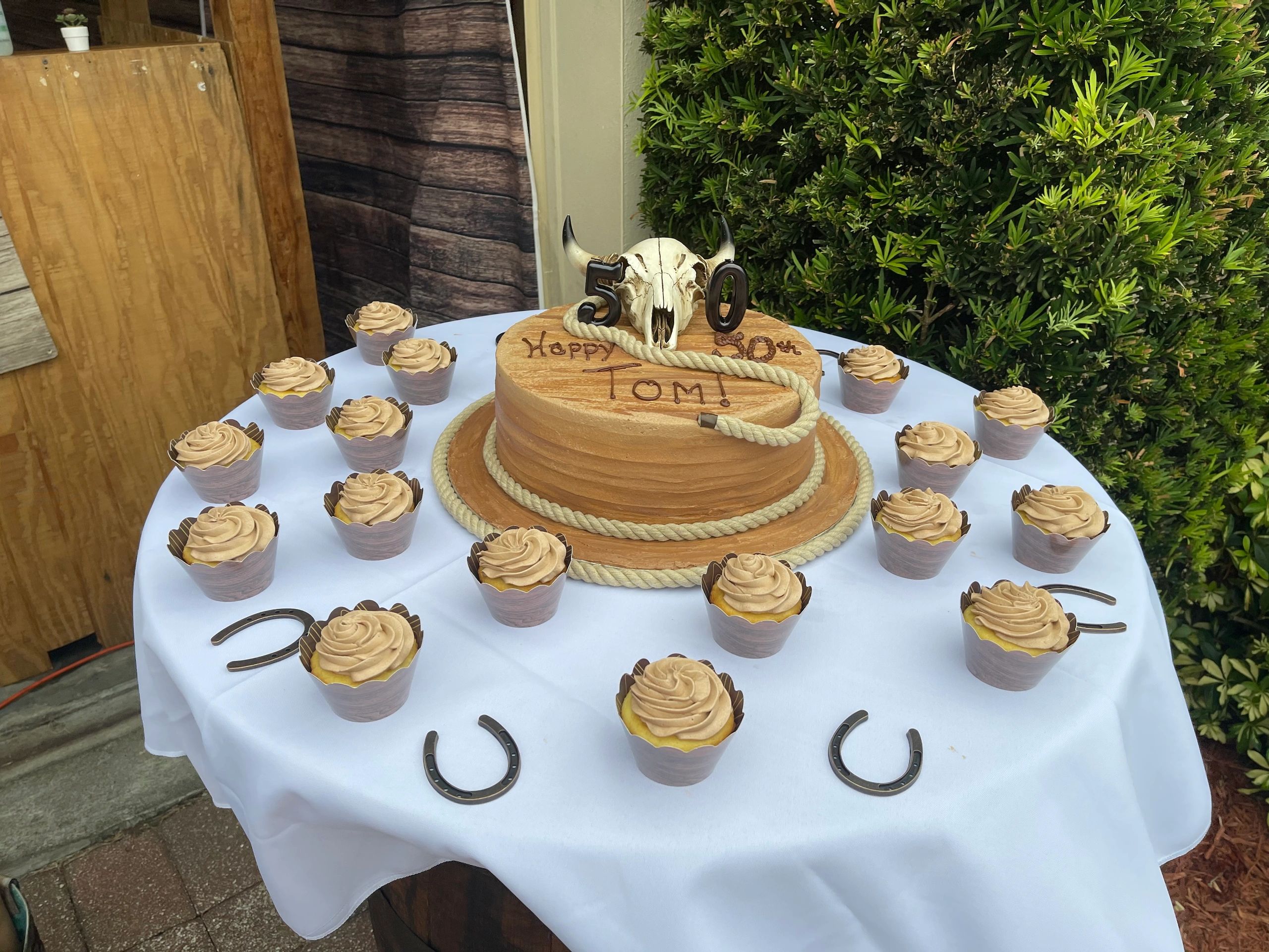 50th birthday cake with a western theme and cupcakes