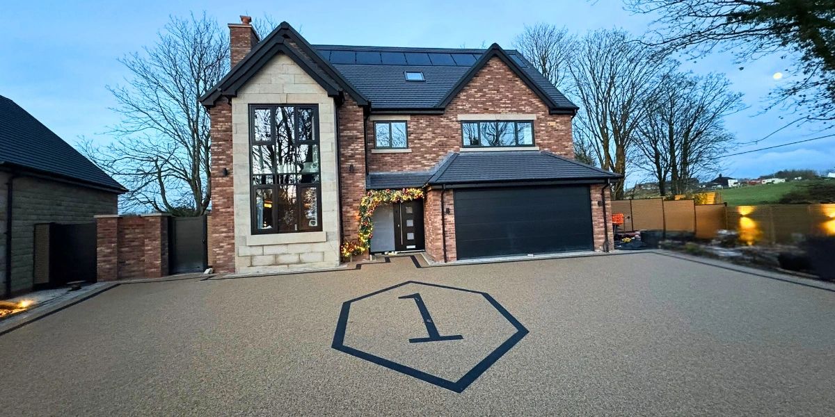 A new resin bound driveway with a new pattern beech colour resin and black resin number design.